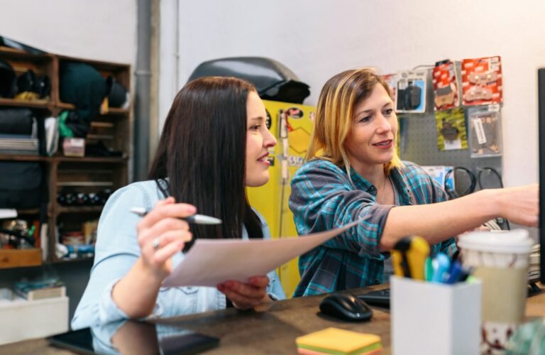 Happy women entrepreneur checking ecommerce new orders on computer